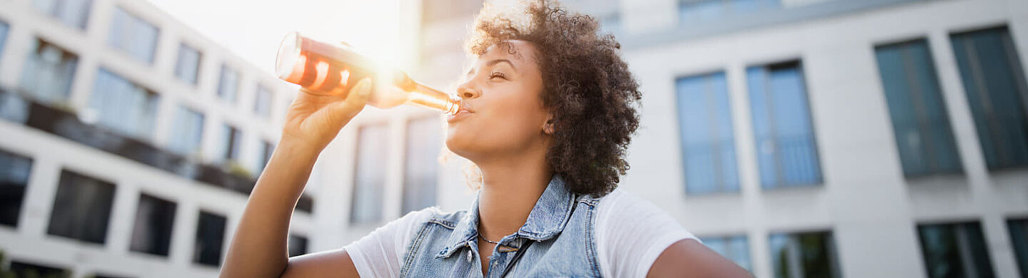 Young woman drinking from a bottle